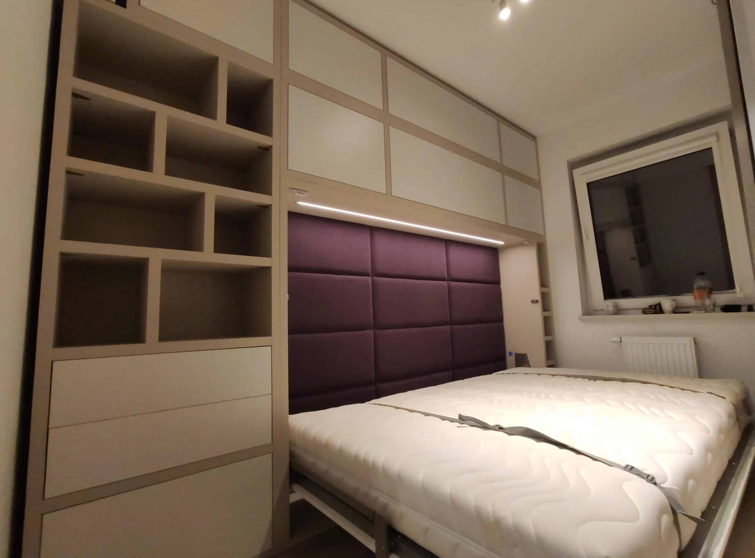 bed with a desk in a wall unit